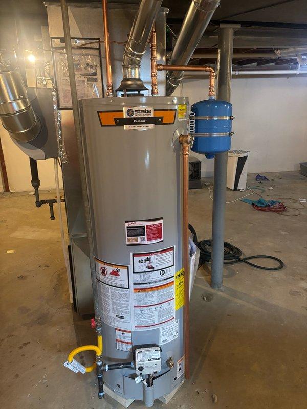 Installed a STATE 40-gallon natural gas water heater (Model GS6-40-BCT 410) with 40,000 BTU/HR input and 42 GPH recovery rate in the basement utility area. Installation included a thermal expansion tank mounted adjacent to the unit and a ball valve emergency shut-off for safety compliance. All copper supply lines, gas connections, and venting were properly configured per manufacturer specifications, with the system tested and verified operational upon completion.