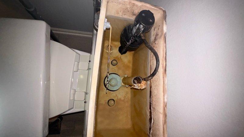 Performed camera scope inspection of drain lines to diagnose slow drainage issues. Inspected toilet tank internals and documented condition of flush valve assemblies, flappers, and fill valve mechanisms in multiple bathrooms, finding significant mineral buildup and aging components requiring replacement. Photographed deteriorated tank components showing discoloration, staining, and worn rubber seals to support recommended repairs for optimal toilet performance.