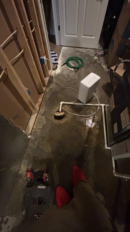 Responded to basement floor drain clog causing significant water accumulation and flooding throughout the work area. Upon arrival, found standing water covering the concrete floor with pooling around the central drain fixture and white PVC piping configuration. Deployed professional drain cleaning equipment and utilized water extraction methods to clear the obstruction and remove standing water from the affected area. Successfully restored proper drainage function to the floor drain system, allowing water to flow freely through the plumbing system.