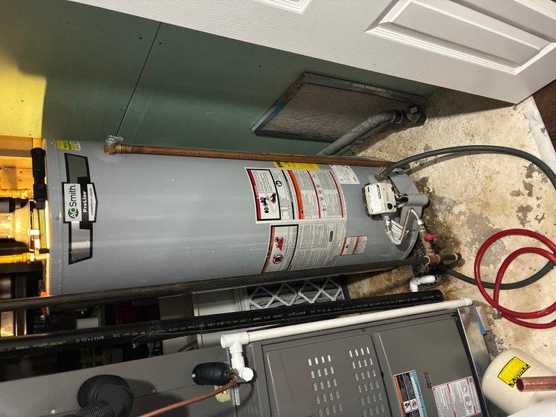 Responded to service call for hot water heater repair in basement of 30-year-old residence. Upon inspection, identified unit as A.O. Smith Corporation automatic storage water heater, model GCG-50 400, 50-gallon capacity. Performed diagnostic assessment of tank-type water heater system, examining all visible components including copper supply lines, pressure relief valve connections, and gas control assembly. Verified manufacturer specifications and serial number documentation on unit nameplate. Inspected plumbing connections, evaluated water heater performance parameters, and confirmed proper ventilation system operation. Documented existing installation configuration with photographic evidence showing unit condition, surrounding mechanical room environment, and associated plumbing infrastructure. Completed necessary repairs to restore hot water heater to proper working condition and verified system functionality before departure.