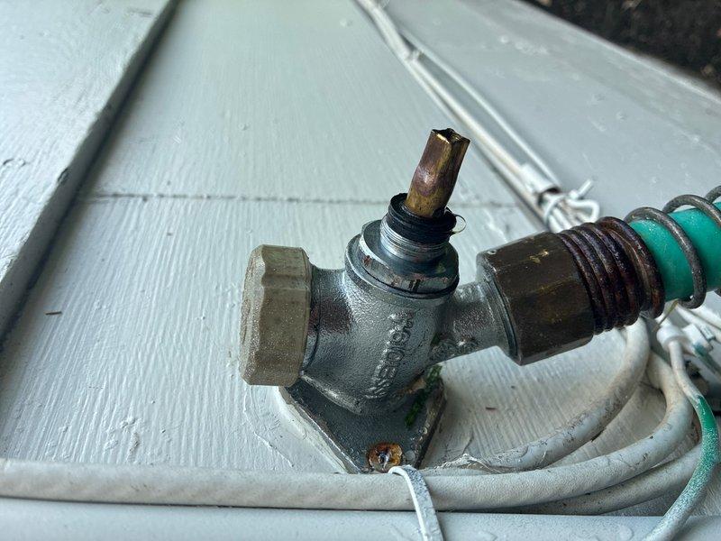 Responded to exterior faucet leak at 50+ year old residence. Upon inspection, found outdoor hose bib with damaged stem and worn valve assembly showing significant weathering and oxidation. Replaced defective spigot assembly, installed new brass hose bib with proper mounting to existing water supply line, and verified all connections were secure with no leaks. System tested and returned to full operation.