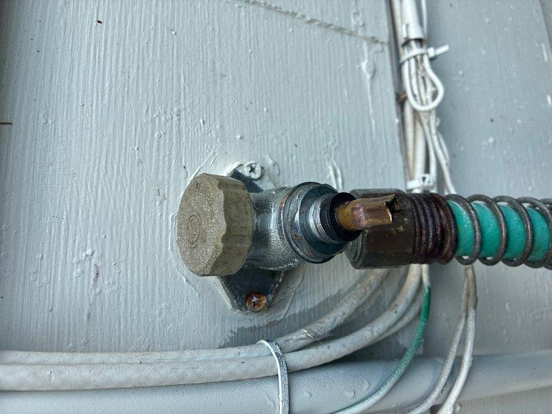 Responded to exterior faucet leak at 50+ year old residence. Upon inspection, found outdoor hose bib with damaged stem and worn valve assembly showing significant weathering and oxidation. Replaced defective spigot assembly, installed new brass hose bib with proper mounting to existing water supply line, and verified all connections were secure with no leaks. System tested and returned to full operation.