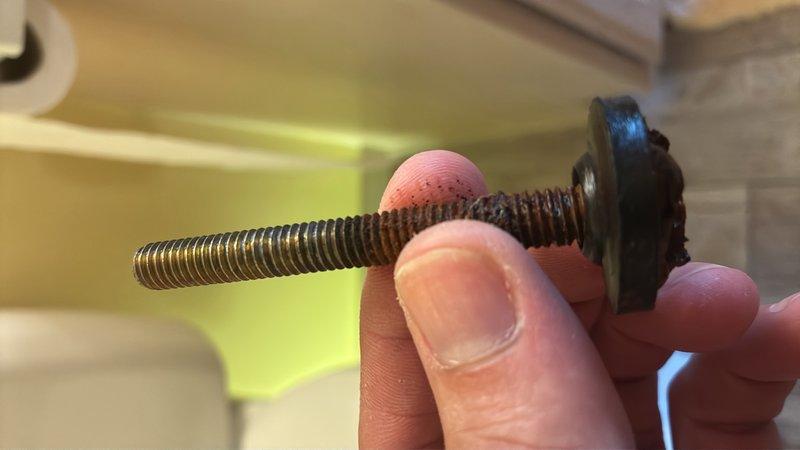 Responded to service call for toilet leaking at floor level. Upon inspection, identified failed wax ring seal and corroded closet bolts as source of water infiltration. Removed toilet from flange, cleared old wax ring residue, and assessed flange condition. Replaced closet bolts with new corrosion-resistant hardware and installed new wax ring seal. Reinstalled toilet, torqued bolts to proper specification, and verified level installation. Tested for leaks by flushing multiple times and confirmed proper seal with no water discharge at base. Documented hardware condition and completed repairs with photographic evidence of removed components and reinstallation process.