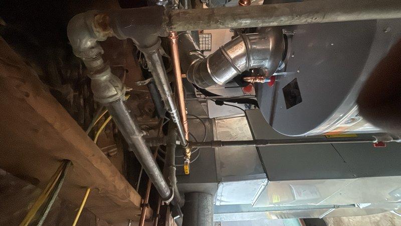 Responded to no hot water complaint caused by pilot light failure on basement water heater. Upon arrival, inspected tanked water heater unit and confirmed pilot light would not remain lit, resulting in complete loss of hot water to residence. Performed diagnostic evaluation of thermocouple, gas control valve, and pilot assembly. Identified faulty thermocouple preventing proper flame detection and causing safety shutoff. Replaced defective thermocouple, cleaned pilot orifice, and tested gas flow to burner assembly. Relit pilot light, verified proper flame characteristics, and cycled unit through multiple heating cycles to confirm reliable operation. Inspected all gas connections for leaks using soap solution. Verified proper venting and combustion air supply. Unit restored to full operational status with consistent pilot flame and hot water production confirmed before departure.