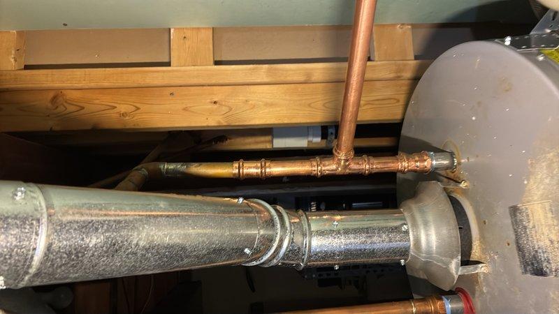 Replaced failed dip tube in tanked water heater and repiped the cold water supply line. Installed expansion tank and mounted it securely to the water heater tank with proper strapping, utilizing copper piping with brass fittings throughout the cold side connections to ensure proper system operation and thermal expansion protection.