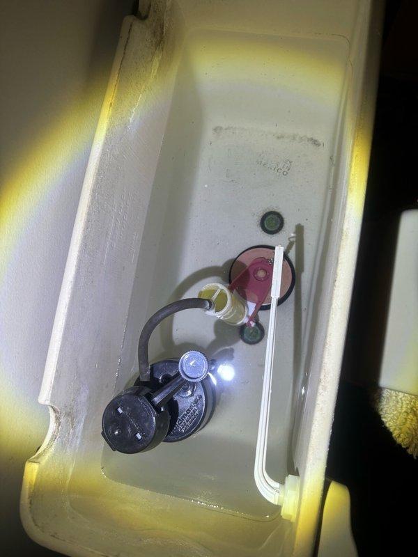 Responded to service call for damaged toilet tank in bathroom. Upon arrival, inspected toilet assembly and confirmed that the tank had sustained structural damage requiring replacement. Documented existing tank with manufacturer markings and model identification for proper replacement ordering. Examined internal tank components including fill valve assembly, flush valve mechanism, and water supply connections. All internal components and supply line connections were photographed to ensure accurate reinstallation during tank replacement. Tank showed significant compromise to structural integrity making repair unfeasible. Recommended complete tank replacement to restore proper function and safety of fixture.