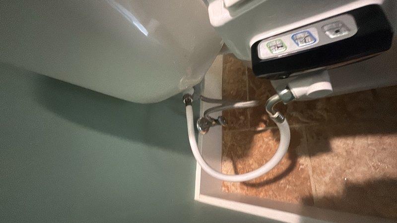 Installed new Essency electric water heater in basement utility area with proper copper piping connections and pressure relief valve. Repaired water leak located above the water heater and installed new 1/4 turn stop valve for humidifier line. Pulled and reset toilet to replace worn wax ring and stool bolts, inspecting and repairing toilet flange as needed to ensure proper seal and prevent future leaks.