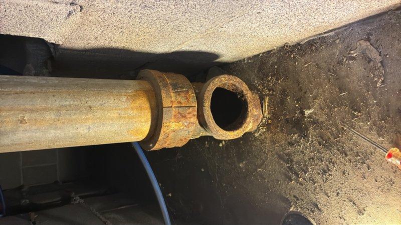 Conducted plumbing estimate for underground piping system replacement due to collapsed pipe. Inspection revealed extensive rust and corrosion on existing metal piping infrastructure located in crawl space, with significant oxidation present on horizontal pipe sections and connection fittings. Documented conditions of deteriorated piping system, including corroded metal flanges and couplings, to provide accurate assessment for complete pipe replacement and system restoration.