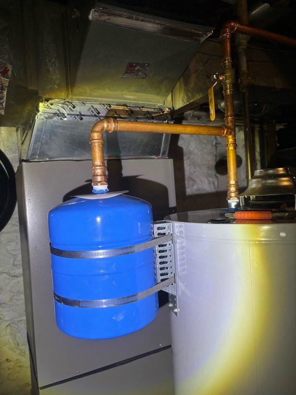 Completed installation of a 40-gallon gas-fired water heater in the basement utility area with all required connections to existing copper supply lines and gas piping. Installed and secured a thermal expansion tank with proper mounting hardware and connected it to the cold water supply line to protect the system from excessive pressure buildup. All connections were tested for proper operation and leak-free performance prior to completion.