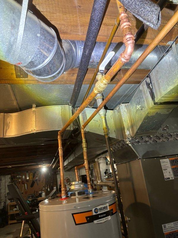 Completed installation of a 40-gallon gas-fired water heater in the basement utility area with all required connections to existing copper supply lines and gas piping. Installed and secured a thermal expansion tank with proper mounting hardware and connected it to the cold water supply line to protect the system from excessive pressure buildup. All connections were tested for proper operation and leak-free performance prior to completion.