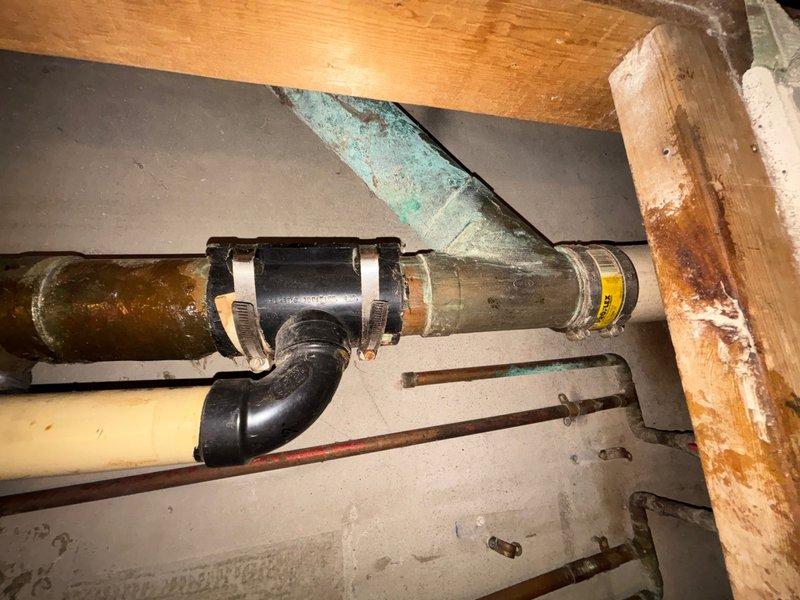 Responded to basement plumbing emergency involving active water accumulation and non-functioning toilet. Upon inspection, diagnosed failed upflush pump system causing backup in basement drain line and preventing toilet operation. Documented corroded copper piping with green patina, aging metal drain lines, and PVC connections showing wear consistent with the 58-year-old home's infrastructure. Assessed structural plumbing configuration including multiple pipe materials and fittings in basement utility space. Provided customer with repair options and recommendations for upflush pump replacement to restore proper drainage and toilet function, taking into consideration budget constraints when presenting solutions.