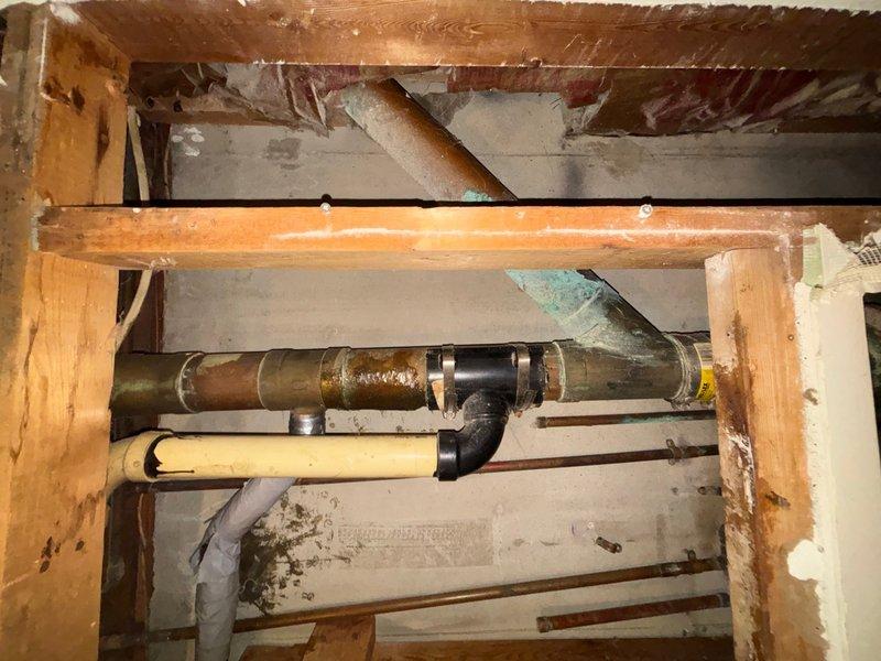 Responded to basement plumbing emergency involving active water accumulation and non-functioning toilet. Upon inspection, diagnosed failed upflush pump system causing backup in basement drain line and preventing toilet operation. Documented corroded copper piping with green patina, aging metal drain lines, and PVC connections showing wear consistent with the 58-year-old home's infrastructure. Assessed structural plumbing configuration including multiple pipe materials and fittings in basement utility space. Provided customer with repair options and recommendations for upflush pump replacement to restore proper drainage and toilet function, taking into consideration budget constraints when presenting solutions.