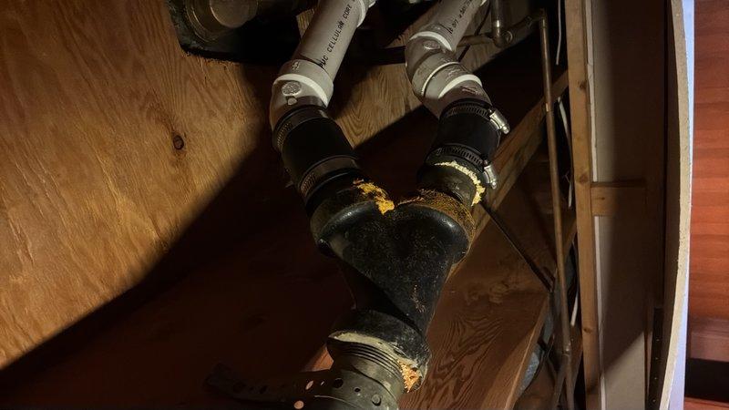 Performed second opinion inspection and video camera evaluation of drainage piping system. Documented floor drain conditions showing corrosion and age-related deterioration at drain openings, as well as inspected sump pump assembly with connecting PVC discharge lines in crawl space area. Identified rust staining and mineral deposits on pump components indicating potential maintenance concerns.
