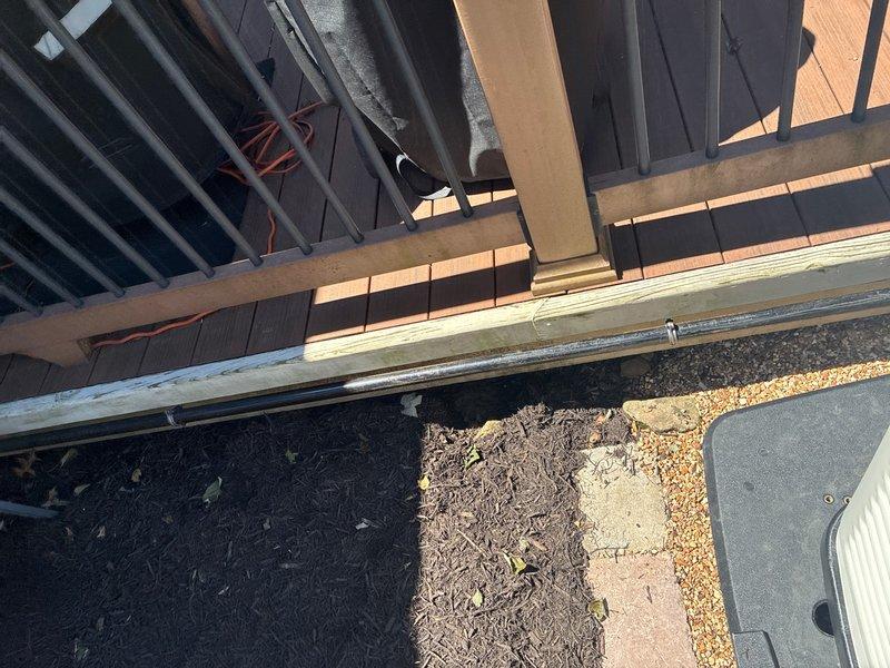 Installed a new 1" gas line from existing basement supply to exterior generator location. Tied into accessible 1" gas line in basement with drop ceiling using a 1" tee fitting and shut-off valve, transitioned to flexible gas line for routing to back wall, then switched back to rigid pipe before penetrating exterior wall. Ran hard pipe along exterior deck perimeter to generator location, installed 90-degree fitting and reduced to 1/2" gas line with shut-off valve and drip leg at generator connection point. Performed pressure testing to verify system integrity and confirm no leaks present. Left gas supply valve in closed position pending generator commissioning.