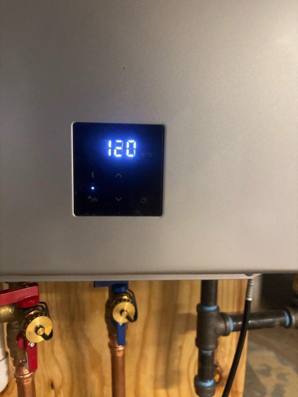 Responded to service call for Rinnai tankless water heater displaying error code 55 in basement. Diagnosed and resolved the issue, verified unit returned to proper operation with temperature control showing 120°F on digital display. Documented installation with photos showing copper piping connections, isolation valves, and proper mounting configuration.