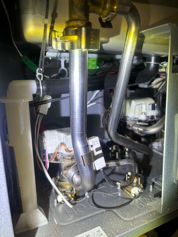 Responded to service call for inconsistent hot water production with intermittent temperature display readings of 12-14 degrees. Upon inspection, discovered customer had tankless water heater unit (Efitech brand) installed in basement utility area, not a tanked water heater as initially categorized. Performed diagnostic evaluation of tankless unit including examination of internal heat exchanger assembly, gas valve connections, and electrical control board. Verified proper venting through PVC exhaust system and confirmed adequate electrical supply from dedicated panel. Inspected brass gas line fittings and flow sensor components for proper operation. Documented equipment condition and installation configuration with photos showing unit mounting, plumbing connections, electrical wiring, and internal mechanical components. Identified potential issues with temperature sensor or control board causing erratic temperature readings and inconsistent heating cycles. Provided customer with findi