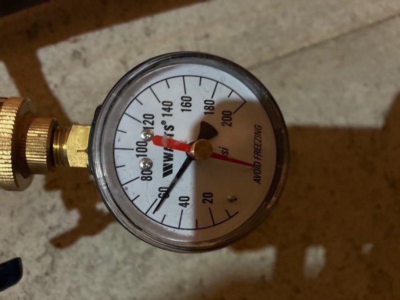 Completed comprehensive whole-home plumbing inspection at residential property with no reported issues. Evaluated accessible plumbing systems including water supply lines, drainage systems, and pressure regulation equipment. Inspected well pressure tank gauge showing dual-scale pressure readings and brass connection fittings in mechanical area, confirming proper system operation and adequate water pressure maintenance. Documented conditions of accessible plumbing infrastructure throughout property for preventive maintenance purposes.