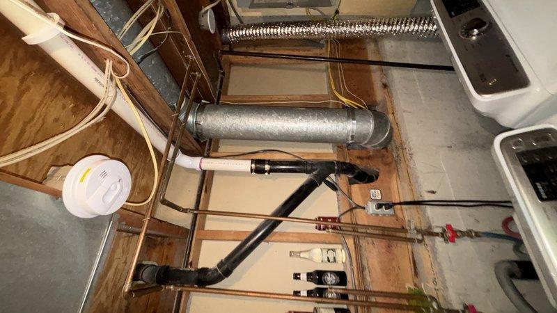 Replaced defective ABS kitchen drain piping in basement due to improper pitch, belly in line, and leaking elbow. Removed affected drain sections and installed new PVC drain piping with proper grade and adequate support to prevent future sagging. Connected new drain to existing trap arms using approved fittings. Installed customer-supplied garbage disposal unit at kitchen sink. Added boiler drain valve at main water shut-off location to facilitate future system servicing and drainage. Diagnosed and repaired loud squealing noise occurring during garbage disposal operation. Secured all piping with appropriate hangers and brackets throughout crawl space and basement areas. Tested all drainage for proper flow, verified leak-free connections at all joints and fittings, and confirmed full functionality of garbage disposal and drain system upon completion.