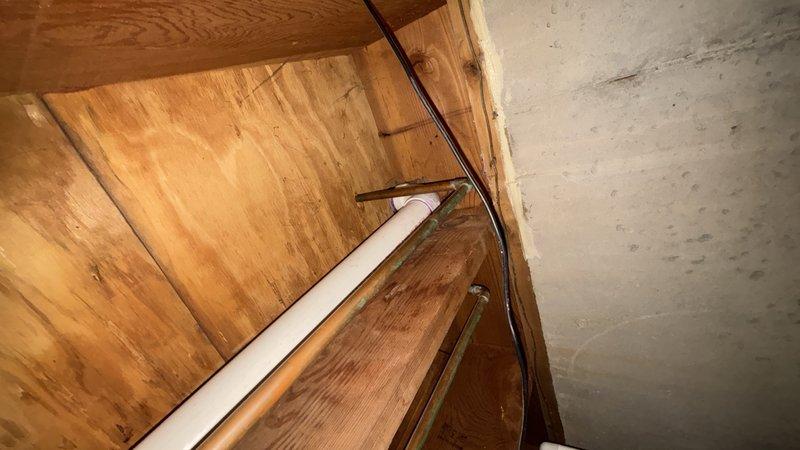Replaced defective ABS kitchen drain piping in basement due to improper pitch, belly in line, and leaking elbow. Removed affected drain sections and installed new PVC drain piping with proper grade and adequate support to prevent future sagging. Connected new drain to existing trap arms using approved fittings. Installed customer-supplied garbage disposal unit at kitchen sink. Added boiler drain valve at main water shut-off location to facilitate future system servicing and drainage. Diagnosed and repaired loud squealing noise occurring during garbage disposal operation. Secured all piping with appropriate hangers and brackets throughout crawl space and basement areas. Tested all drainage for proper flow, verified leak-free connections at all joints and fittings, and confirmed full functionality of garbage disposal and drain system upon completion.