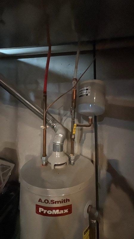 Completed estimate for replacement of existing water heater with new 50-gallon A.O. Smith ProMax unit in basement location. Evaluated current installation including copper supply line connections, temperature and pressure relief valve configuration, and expansion tank setup. Assessed accessibility, venting requirements, and compliance with current plumbing codes for proposed water heater replacement.