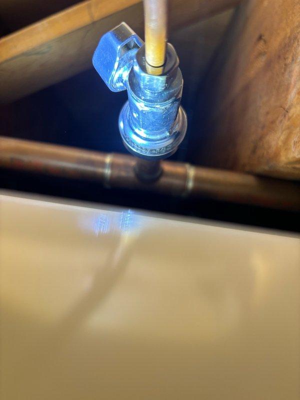 Responded to service call for installation of shut-off valve for refrigerator water line in kitchen. Upon arrival, inspected existing plumbing configuration and identified appropriate connection point for new valve installation. Successfully installed quarter-turn shut-off valve on cold water supply line to provide dedicated shutoff capability for refrigerator ice maker and water dispenser. Tested valve operation and checked for proper sealing with no leaks detected upon completion.