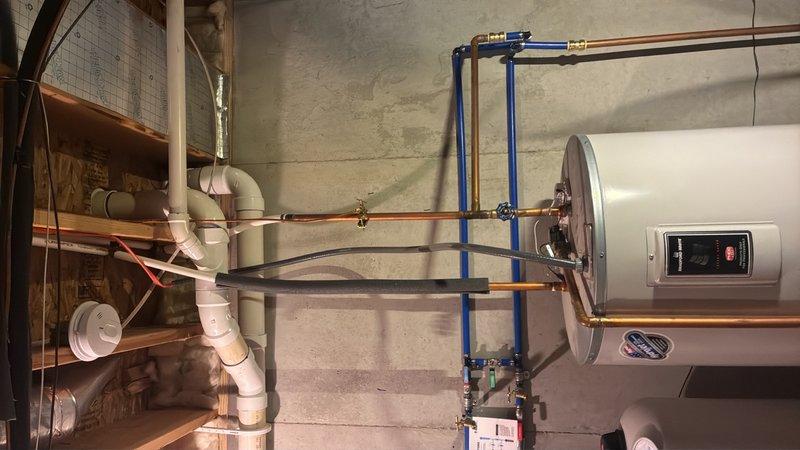Provided estimate for water heater replacement in basement location. Evaluated existing Bradford White automatic storage water heater installation with copper piping and PEX connections. Presented customer with options for either an 80-gallon conventional storage tank water heater or tankless water heater system. Documented current equipment specifications and photographed existing installation including water connections, venting configuration, and available workspace for replacement unit.