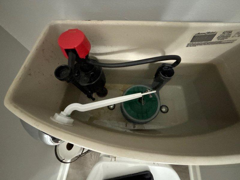 Responded to callback for two toilets not flushing properly following previous service. Inspected both bathroom toilet tanks and identified issues with flush mechanisms. Found discolored water and mineral deposits in tank indicating potential flapper valve deterioration affecting flush performance. Adjusted fill valve settings and tested flush operation on both toilets to restore proper flushing function.