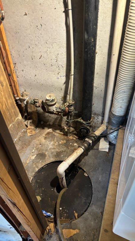 Responded to a main drain cleanout service request in the garage area. Upon arrival, accessed the cleanout point located in a utility space with multiple plumbing lines and mechanical components. The drain system extended 68 feet deep from the access point. Performed thorough cable snaking of the main drain line to remove blockages and restore proper flow. The work area showed evidence of previous drainage issues with sediment accumulation around the cleanout basin and floor surfaces. Successfully cleared the line and verified proper drainage function. Cleaned work area and secured all access covers upon completion.