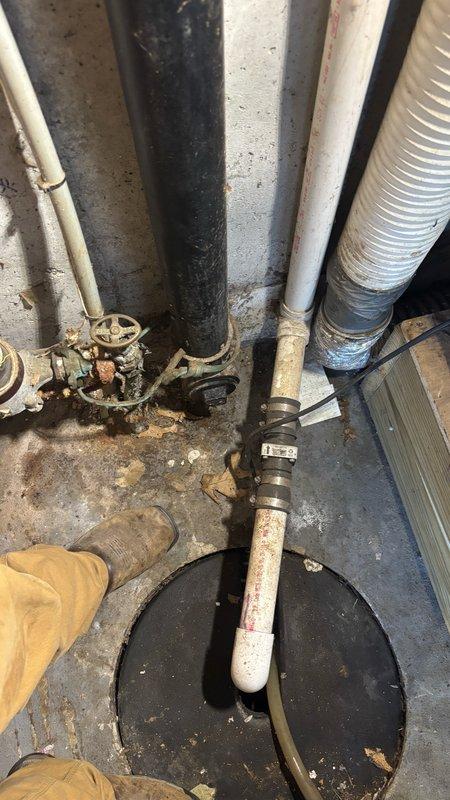 Responded to a main drain cleanout service request in the garage area. Upon arrival, accessed the cleanout point located in a utility space with multiple plumbing lines and mechanical components. The drain system extended 68 feet deep from the access point. Performed thorough cable snaking of the main drain line to remove blockages and restore proper flow. The work area showed evidence of previous drainage issues with sediment accumulation around the cleanout basin and floor surfaces. Successfully cleared the line and verified proper drainage function. Cleaned work area and secured all access covers upon completion.
