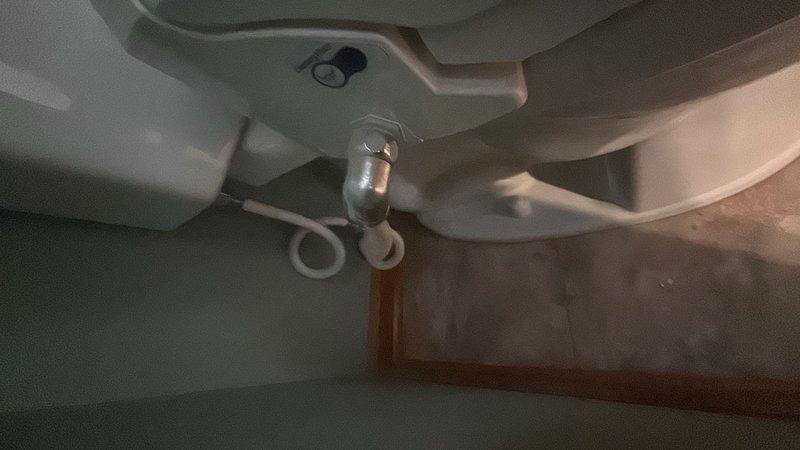 Conducted on-site assessment for Toto toilet installation to replace existing fixture. Evaluated current toilet condition, noting rust staining and mineral deposits on underside of bowl and plumbing connections, and documented existing flush valve assembly and mounting configuration. Provided estimate for complete toilet replacement, taking advantage of manufacturer's promotional offer for new Toto unit installation.