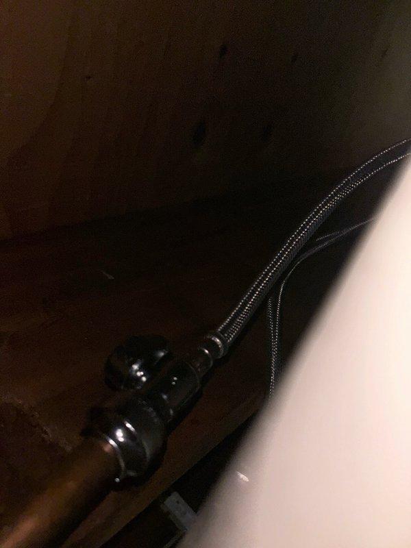 Installed ice maker supply line from appliance location to quarter turn shut-off valve in basement area. Routed copper piping through ceiling joists and secured with appropriate mounting brackets to wooden framing members. Connected braided stainless steel flex line from supply pipe to appliance connection point, ensuring proper fittings and leak-free connections throughout the installation.