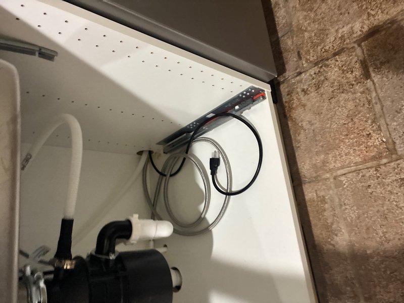 Installed new drain line for kitchen sink and completed full hookup of faucet and dishwasher. Remounted garbage disposal unit and installed new 1/4 turn angle stops for both faucet supply lines and dishwasher connection. All plumbing connections tested and verified leak-free with proper drainage flow confirmed.