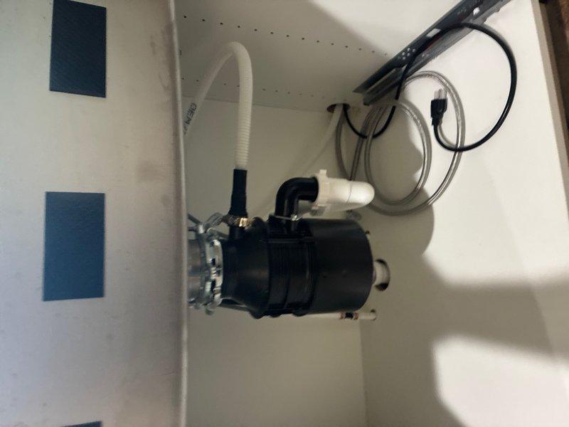 Installed new drain line for kitchen sink and completed full hookup of faucet and dishwasher. Remounted garbage disposal unit and installed new 1/4 turn angle stops for both faucet supply lines and dishwasher connection. All plumbing connections tested and verified leak-free with proper drainage flow confirmed.