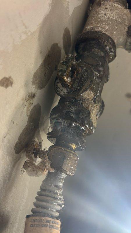 Responded to gas leak report behind water heater identified by HVAC technician. Upon inspection, discovered heavily corroded gas pipe assembly with extensive rust deterioration throughout multiple connection points and valve fittings. The corrosion had compromised the integrity of the piping system, creating a hazardous leak condition. Removed and replaced the failed corroded pipe assembly, including deteriorated brass fittings, threaded unions, and valve connections. Installed new gas-rated piping and fittings to restore safe gas delivery to the water heater. Performed pressure test on completed installation to verify system integrity and confirm no leaks present. Restored gas service and verified proper operation of water heater.