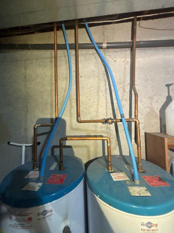 Conducted comprehensive assessment of dual 10-year-old electric water heaters in basement utility room to provide replacement estimate. Both units currently operational with standard copper piping and PEX distribution lines. Evaluated existing electrical connections, plumbing infrastructure including hot and cold water supply lines, pressure relief valve configurations, and drainage requirements for future replacement planning.