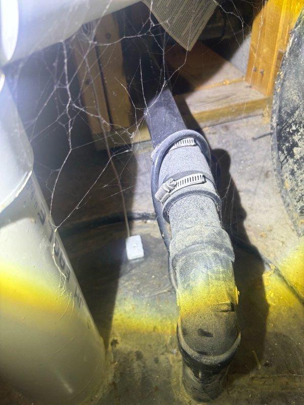 Conducted plumbing estimate for sump pump replacement in basement mechanical space. Assessed existing 10-year-old sump pump system currently in operational condition, including discharge piping with visible PVC connections secured by metal clamps and basin configuration. Documented equipment condition, surrounding utility space access, and provided recommendations for replacement options to ensure continued reliable basement water management.