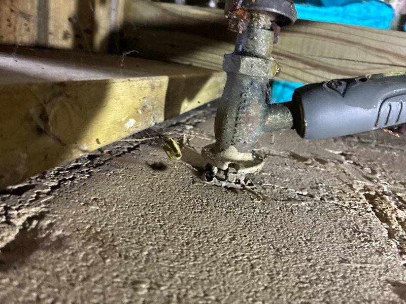 Responded to reported water leak at residential property. Upon inspection, identified severely corroded outdoor hose bib with visible rust staining and oxidation around the spout and valve body. The brass fixture showed significant deterioration due to extended weather exposure. Additionally, inspected crawl space plumbing connections and discovered corroded pipe fittings with brownish-red oxidation on metal joints, indicating advanced deterioration of the piping system. Documented all affected areas with photographs showing the extent of corrosion on both the exterior hose bib and interior pipe connections. Provided estimate for replacement of corroded fixtures and repair of deteriorated piping components to prevent further water damage and restore proper function to the plumbing system.