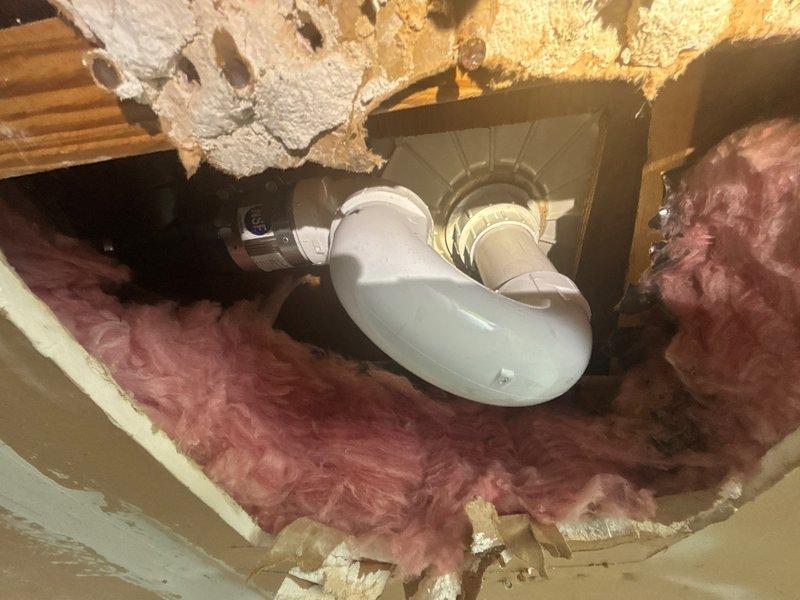 Successfully replaced a defective PVC shower drain assembly with a new chrome-plated drain cover featuring a diamond-pattern perforated grate secured with stainless steel screws. The replacement drain was properly installed within the existing white ceramic drain ring on the textured non-slip shower floor surface, restoring full drainage functionality to the shower unit.
