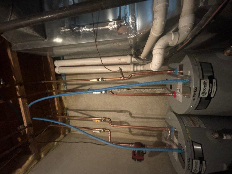 Installed two 50-gallon A.O. Smith electric water heaters with thermal expansion tanks in the mechanical room. Added a 3/4" pressure reducing valve to the incoming water supply and installed a pop-up drain assembly with one hour of additional labor for proper fixture installation.

Integrated a Grundfos hot water recirculation system featuring a stainless steel circulator pump with built-in timer and 10-foot power cord mounted directly to the hot water discharge at the water heaters. Installed the comfort valve under the sink at the fixture furthest from the water heaters, utilizing the existing cold water line as a return path to eliminate the need for dedicated return plumbing. System configured to reduce wait time for hot water delivery and minimize water waste while requiring no electrical connections at remote fixtures.
