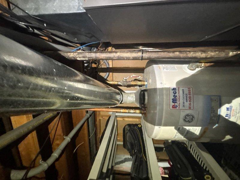 Responded to reported water filter system malfunction in basement area. Upon arrival, inspected basement utility space and mechanical systems to locate and diagnose the water filtration issue. Examined water lines, connections, and filter housing in the vicinity of HVAC equipment and water heater. Assessed system operation and identified the source of the malfunction. Performed necessary repairs to restore proper water filter system functionality. Documented conditions with photographs showing basement floor area and mechanical space configuration. System tested and confirmed operational upon completion of service call.