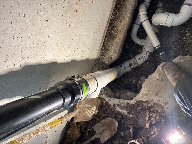 Installed new backwater valve on main sewer line in garage. Jackhammered concrete floor to access existing sewer line, relocated bathroom drain connection to accommodate backwater valve installation, and completed all plumbing connections with PVC piping. Following pressure testing and inspection, backfilled excavation, removed all debris, poured new concrete flush with existing garage floor, installed access cap on backwater valve, and completed final cleanup.
