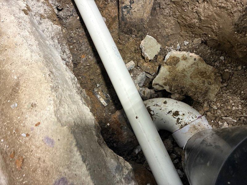 Installed new backwater valve on main sewer line in garage. Jackhammered concrete floor to access existing sewer line, relocated bathroom drain connection to accommodate backwater valve installation, and completed all plumbing connections with PVC piping. Following pressure testing and inspection, backfilled excavation, removed all debris, poured new concrete flush with existing garage floor, installed access cap on backwater valve, and completed final cleanup.