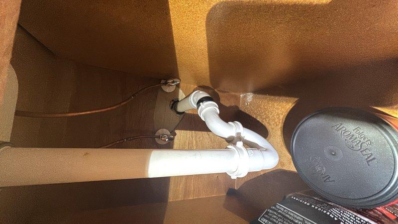 Completed complimentary plumbing inspection of residential property. Inspected bathroom sink drain assembly, confirming proper P-trap configuration and PVC connections, and evaluated water heater installation including venting and safety components. Documented findings with photographs and provided detailed inspection report to homeowner via email.
