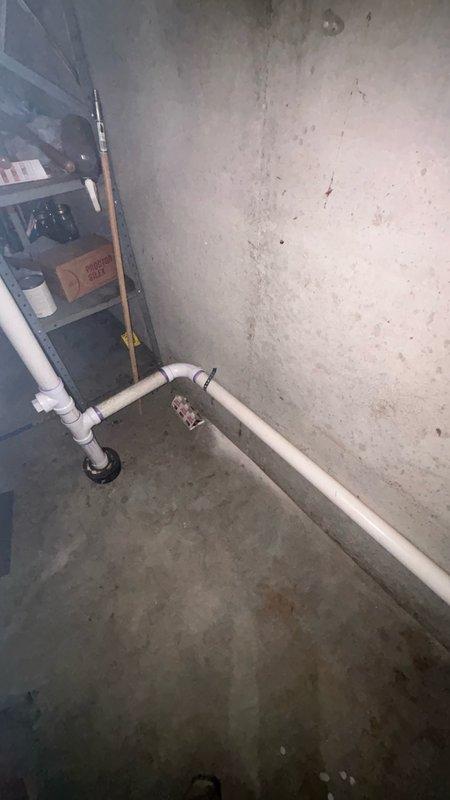 Relocated laundry drain line in basement utility area by cutting and removing existing drain configuration, capping off original connection point, and installing new 2-inch PVC drain line along concrete foundation wall. Routed new drain line with proper pitch and reconnected to existing kitchen drain line using appropriate fittings and elbow joints. Tested system for proper flow and verified all connections were leak-free upon completion.