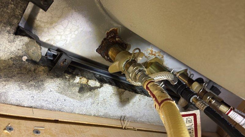Responded to service call for low water pressure at kitchen sink and reported leak at garbage disposal. Upon inspection, identified leak at garbage disposal drain connection and corroded supply line fittings beneath sink. Tightened garbage disposal mounting flange and discharge elbow connection to eliminate leak. Inspected under-sink plumbing and noted corrosion on brass supply fittings affecting water flow. Replaced corroded supply line components and verified proper water pressure restoration at faucet. Tested garbage disposal for proper operation and confirmed all connections sealed with no active leaks. System returned to normal operating condition.
