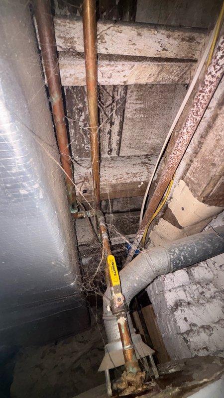 Responded to service call for backed-up dishwasher water line in kitchen area. Upon inspection, accessed crawl space and basement utility area to locate and assess the drainage system. Identified blockage in the dishwasher drain line and cleared obstruction using appropriate plumbing tools. Inspected associated drainage pipes, including vertical PVC drain stack and copper supply lines, to ensure proper flow and verify no additional issues with the water treatment or drainage system. Tested dishwasher water line for proper drainage and confirmed system restored to normal operation.
