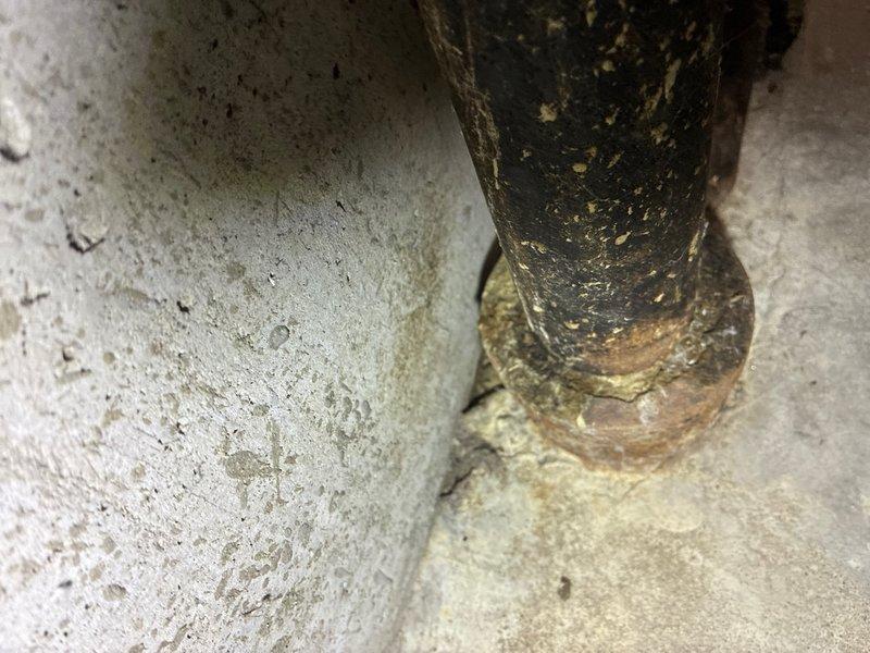 Responded to leak investigation call for basement plumbing issue. Upon arrival, conducted thorough inspection of cast iron drain system. Located severely corroded cast iron drain pipes at floor and wall junction showing extensive surface deterioration, flaking coating, and heavy rust accumulation. Documented pipe condition with photographs revealing compromised pipe integrity at base flange connection and vertical-to-horizontal pipe junction. The advanced corrosion and pitting observed on the cast iron drain lines indicated prolonged moisture exposure and age-related degradation, consistent with reported leak concerns. Advised customer of findings and recommended replacement of affected cast iron drain sections to prevent future leakage and potential water damage.