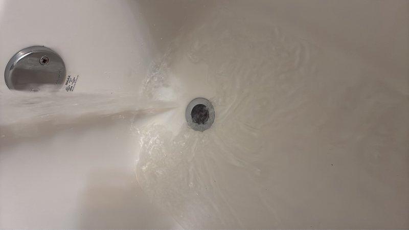 Responded to water leak concerns in kitchen and basement areas of 15-year-old residential property. Upon inspection, identified bathtub drain assembly requiring attention, with visible water staining and mineral deposits on tub surface indicating potential overflow or drainage issues. Removed and inspected drain cover and overflow plate, checking for proper sealing and secure mounting. Cleaned drain assembly, resealed fixtures, and verified proper water flow to prevent future leakage into lower levels.