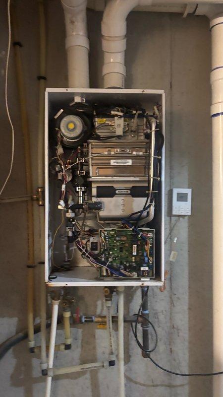 Responded to service call for tankless water heater malfunction in basement of residential property. Upon arrival, performed comprehensive diagnostic inspection of unit, removing front access panel to examine internal components including heat exchanger, ignition system, circuit board, gas valve assembly, and blower motor. Identified and resolved operational issue affecting unit performance. Verified proper function of all safety controls, gas connections, and venting system. Tested unit through multiple heating cycles to confirm restored hot water delivery and proper shutdown sequence. Left equipment in fully operational condition.