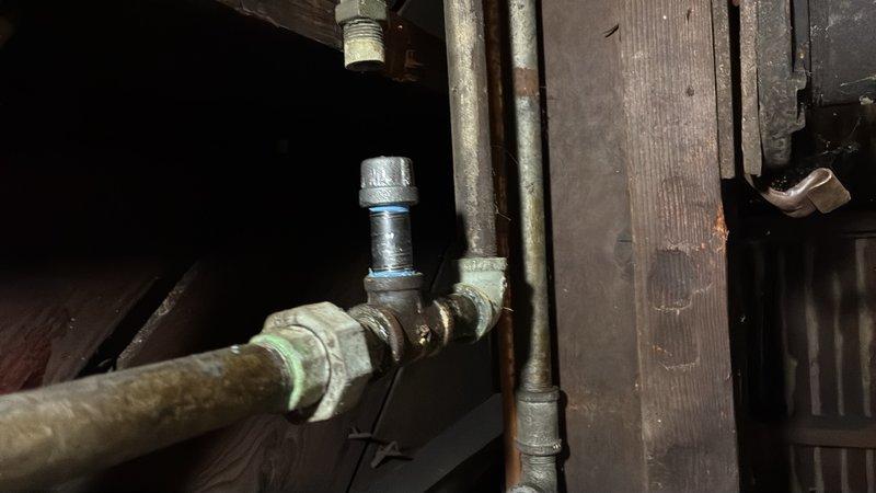 Capped three abandoned 1/2" gas lines in the basement—two lines running above ductwork and one line extending to a decommissioned gas lantern in the backyard. Performed gas pressure testing on both gas line systems to verify integrity and check for leaks as required by the city or gas company for service restoration. No permit was required as no new gas lines were added to the existing system.
